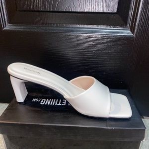 white curved mini heel mules